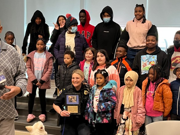 The first female officer for the Richmond Heights PD, Denise DeBiase, retired in early May after almost 28 years. She is shown posing with some local youths as part of her many roles touching the community as a DARE and K-9 officer. (Submitted)